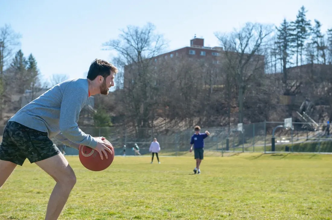 Student holding a kickball.